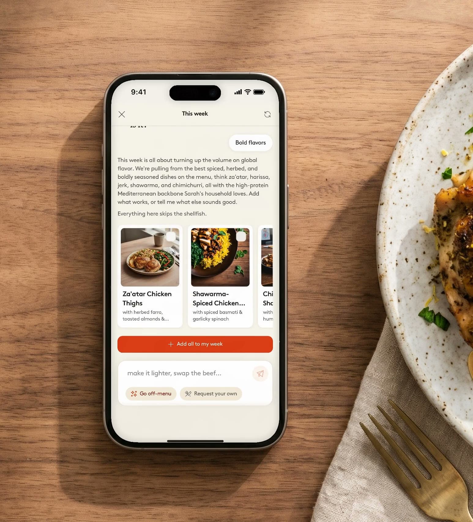 Livin's planner on a phone beside a plated dinner, dealing a week of dishes that all skip the shellfish